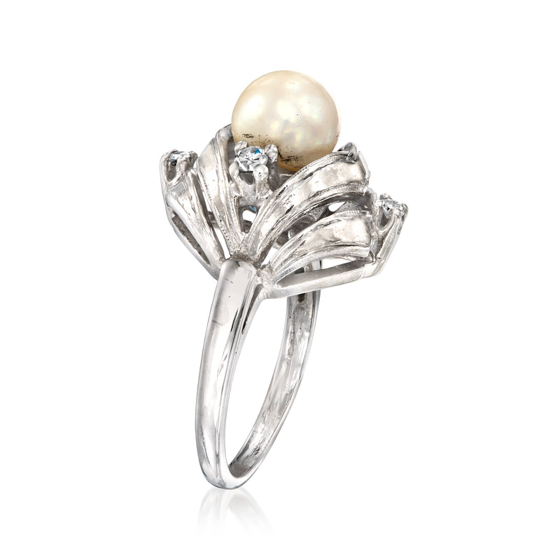 White gold ring with large round cultured pearl and prong-set diamond clusters