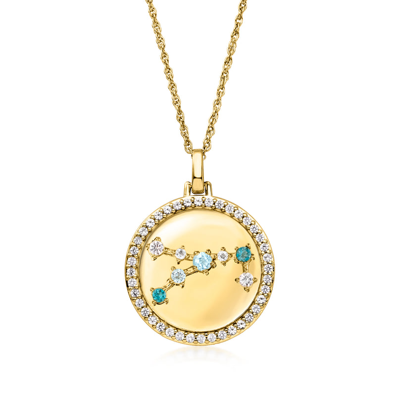 Gold tone zodiac constellation pendant necklace with blue and clear stones in a round halo