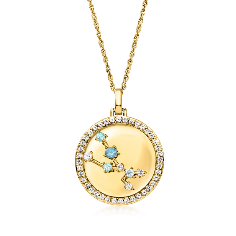 Gold tone zodiac constellation pendant necklace featuring blue stones on a gold disc bezel