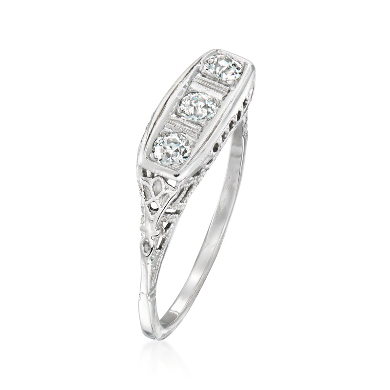 Three-stone diamond ring, raised bezel setting on white gold band