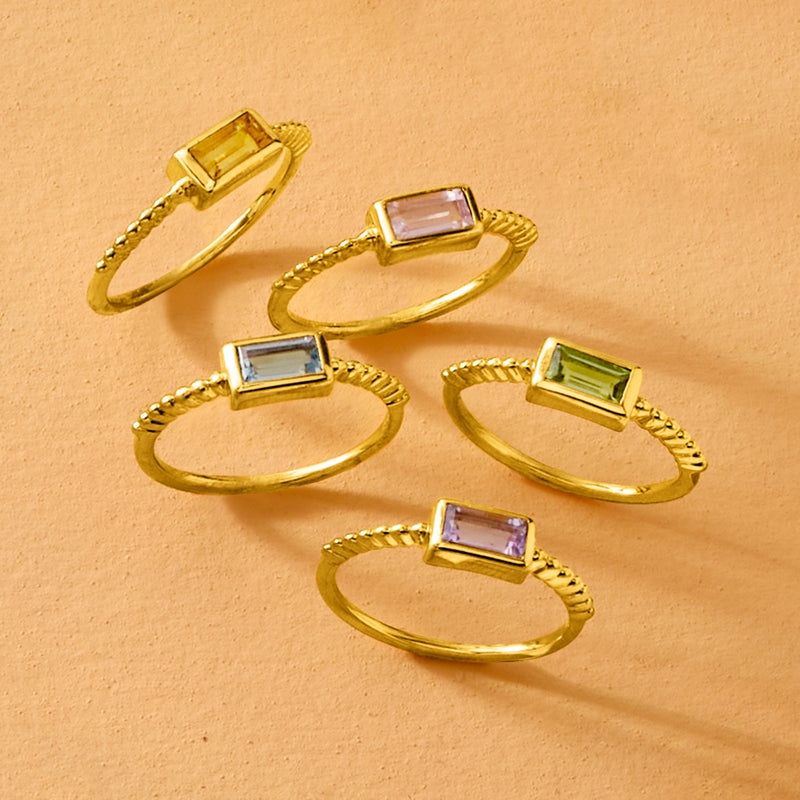 Gold-tone five rings with rectangular purple, green, and light-blue gemstones
