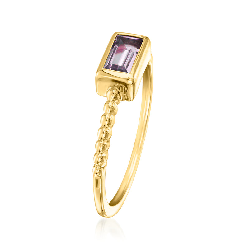 Gold-tone ring with rectangular purple gemstone and chain detail at the band