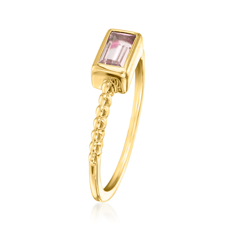 Gold-tone ring with rectangular purple gemstone and dangling chain detail