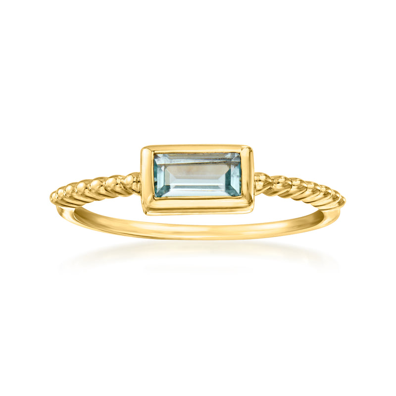 Gold-tone ring with rectangular blue gemstone and braided band