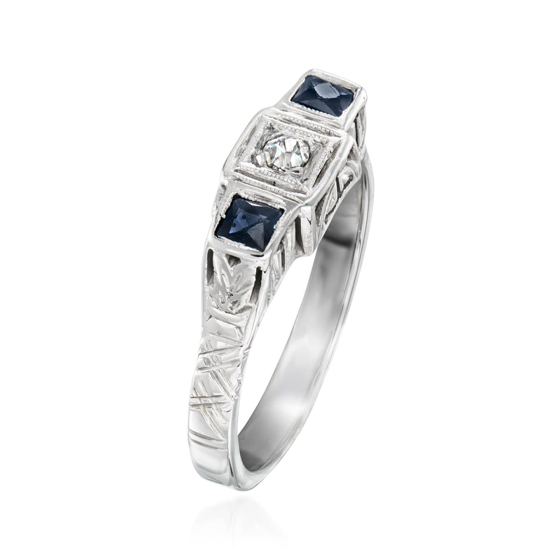 Vintage white gold ring side view with dark blue sapphire accents and center diamond