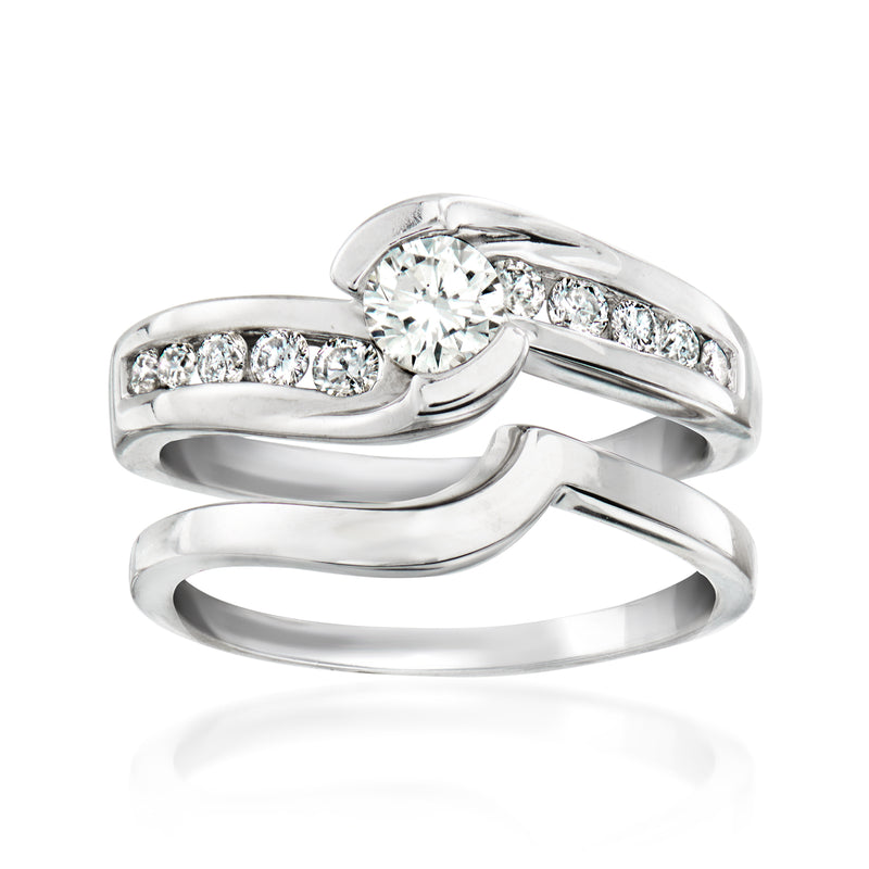 14kt white gold diamond ring set: round center stone with side diamonds, polished bands