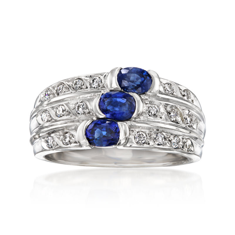 Platinum sapphire and diamond three-stone ring with blue oval gems and diamond accents