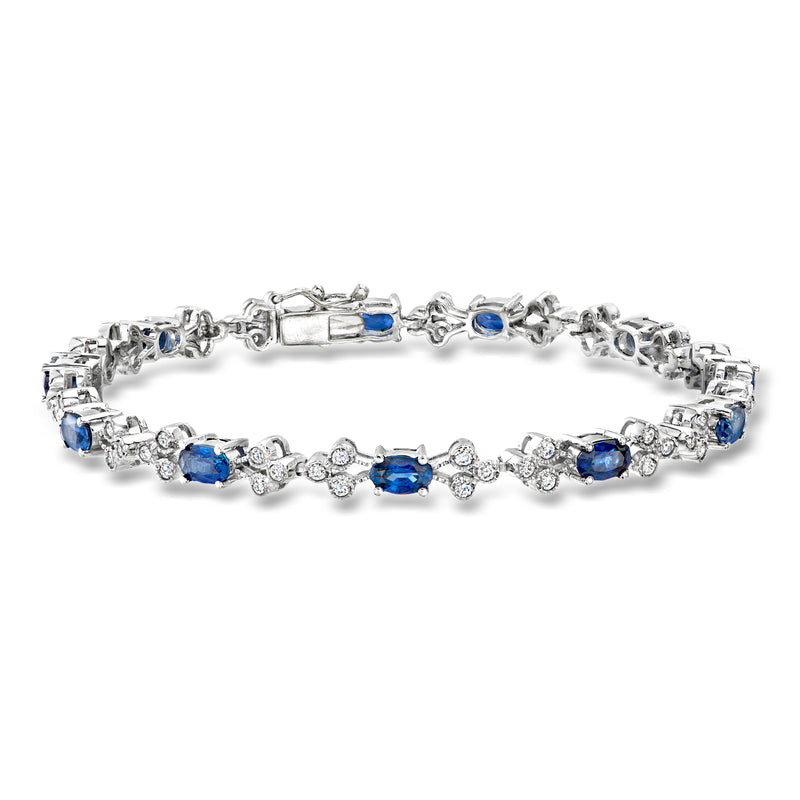 14kt white gold bracelet with oval blue sapphires and round diamond accents, tennis style