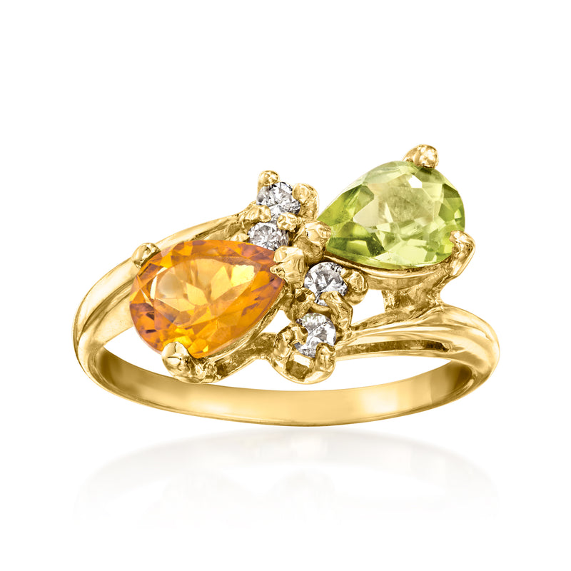 Yellow gold ring with oval orange and green gemstones and diamond accents, prong set