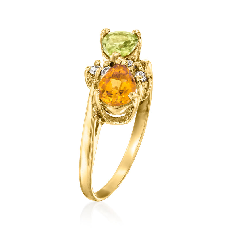 Yellow gold ring featuring stacked oval orange and green gemstones with diamond side accents