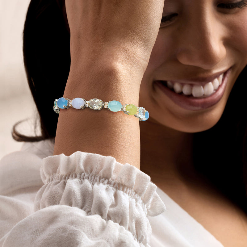 Sterling silver pastel gemstone bracelet on wrist with blue, green, and light opal-toned stones