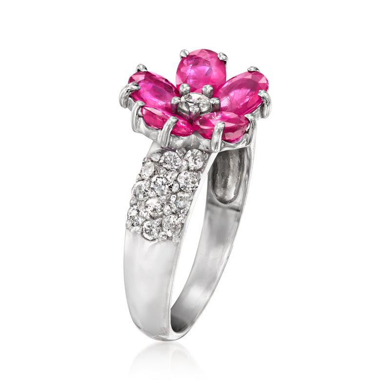 White gold ruby flower ring with three pink oval stones and clustered diamond sidestones