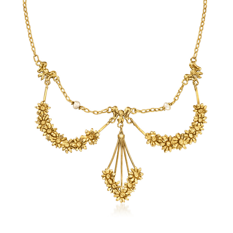 Yellow gold bib necklace with floral links, cultured pearl accents, and teardrop pendant