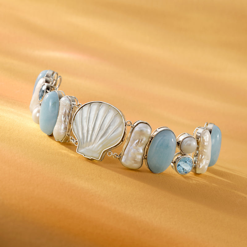 Sterling silver sea bracelet with blue ovals, shell centerpiece, pearls, and small round accents