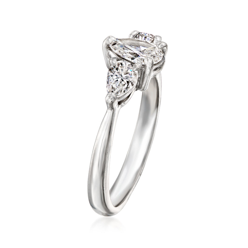 Platinum pear-shaped diamond ring, side view with three-stone setting