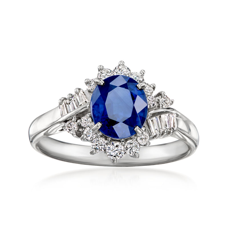 Platinum ring with oval blue sapphire center and diamond halo, baguette accents