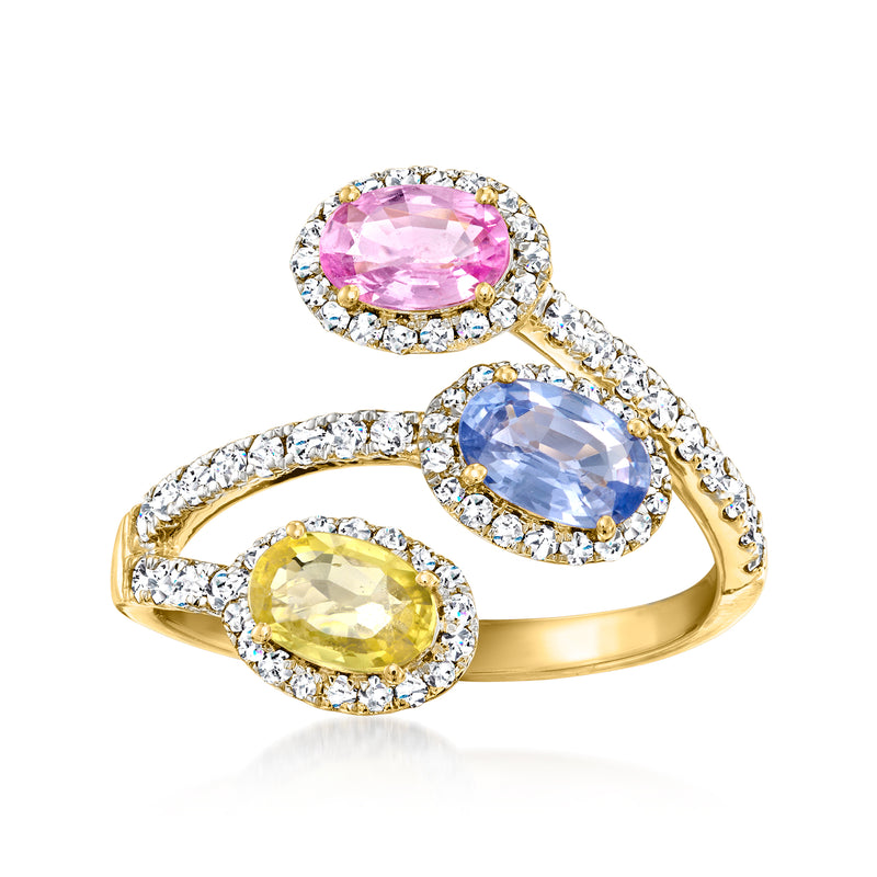 14kt yellow gold bypass ring with pink, blue, and yellow oval sapphires and diamond halos