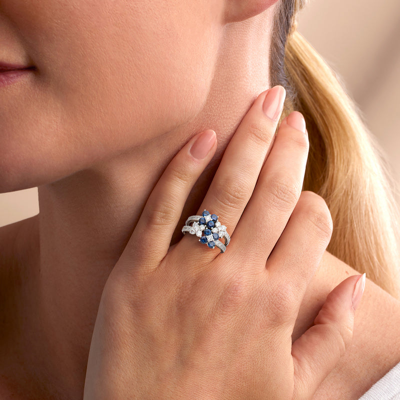 Vintage sapphire and diamond ring on hand, blue center stones with diamond accents