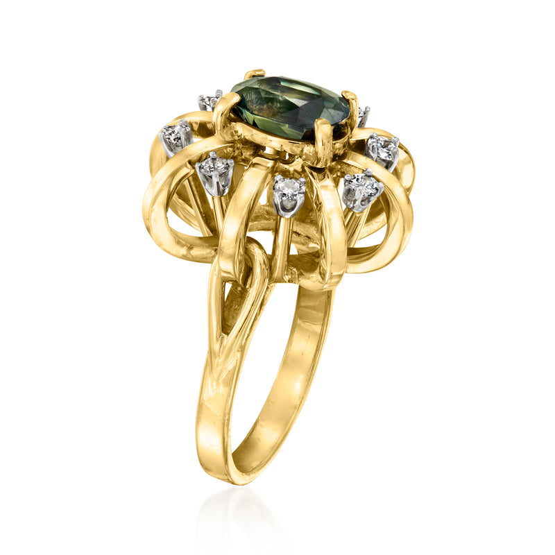 Yellow gold ring featuring oval green sapphire and round diamond side stones