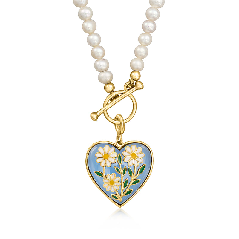 Close-up heart charm on pearl necklace: blue enamel daisies with gold accents