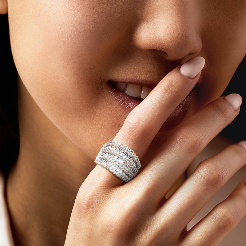 Diamond multi-row ring on finger, white gold band with round and baguette stones