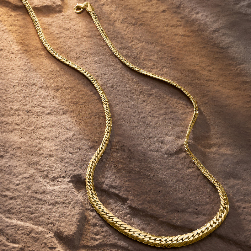 10kt yellow gold graduated Cuban-link necklace with clasp detail, laid flat