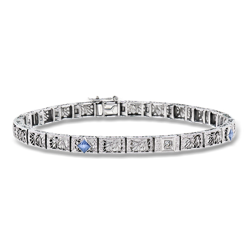 Vintage filigree bracelet in silver tone with blue center stone and diamond accents