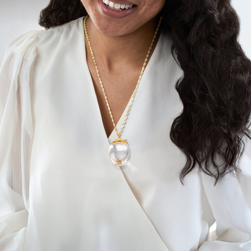 Strawberry pendant necklace on model with 18kt yellow gold chain and clear quartz-look fruit