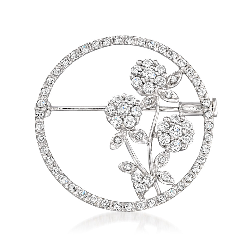 Vintage diamond flower pin in white gold, round halo with three clustered blossoms.