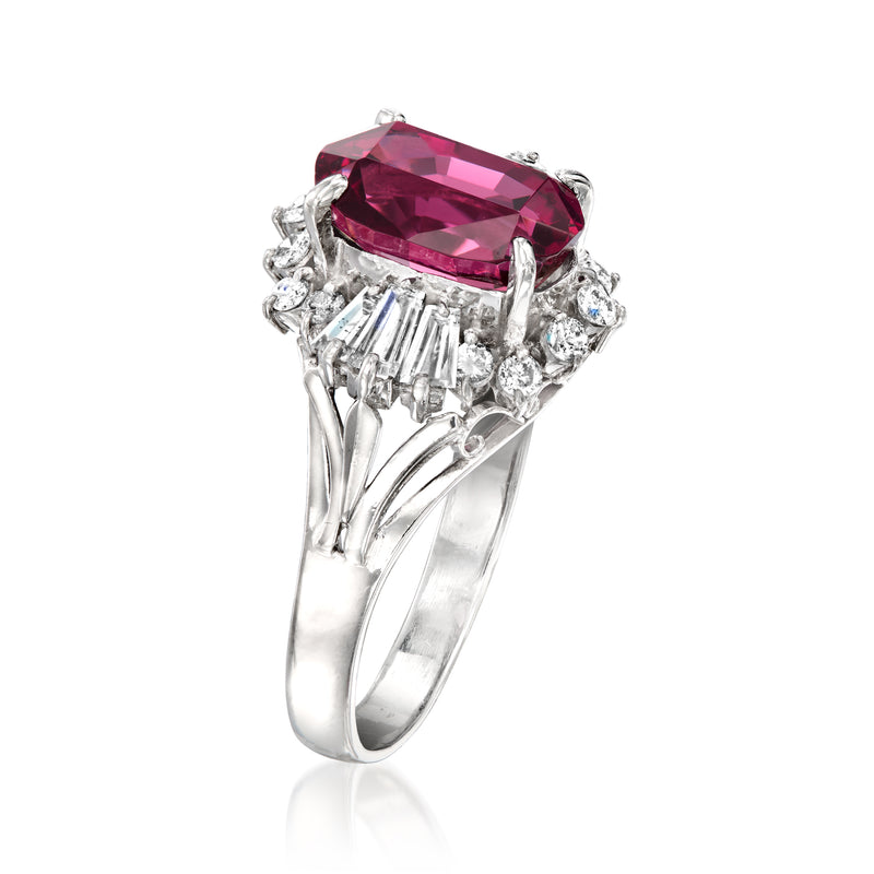 Platinum ring with oval rhodolite garnet center and diamond side cluster accents