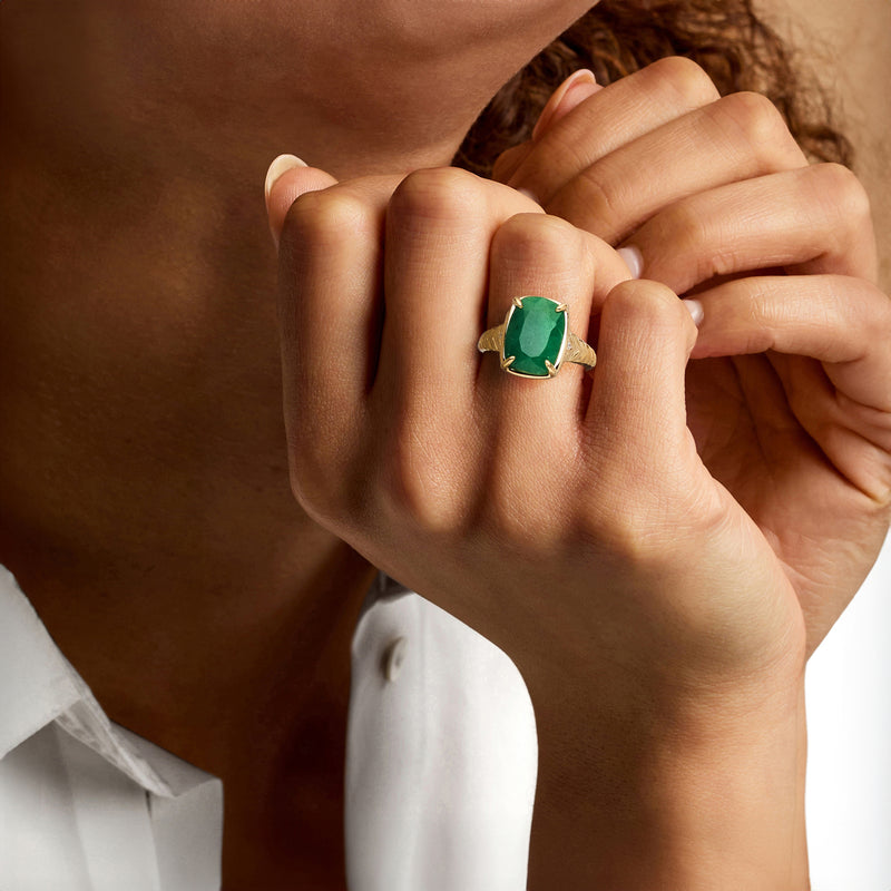 Gold emerald green square-ring bezel on finger with small diamond details