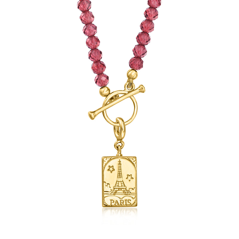Gold Paris postcard charm with pink gemstones on a red beaded necklace