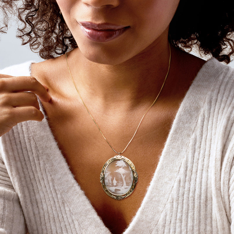 Two-tone oval cameo pendant on thin gold chain, pale white shell landscape scene