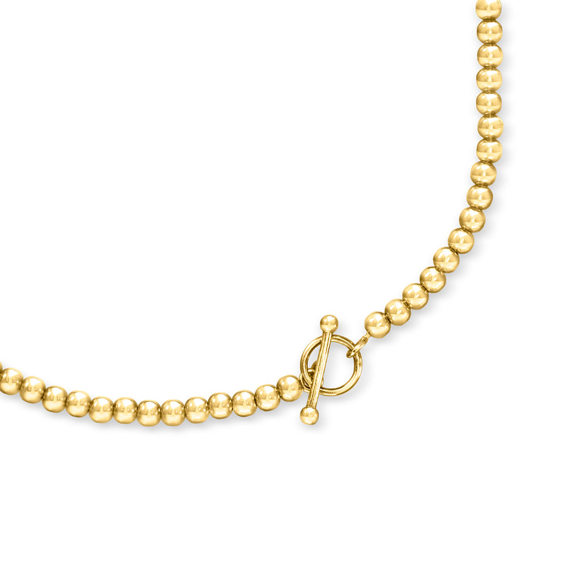 Gold bead-chain necklace with spring-ring clasp and small heart detail