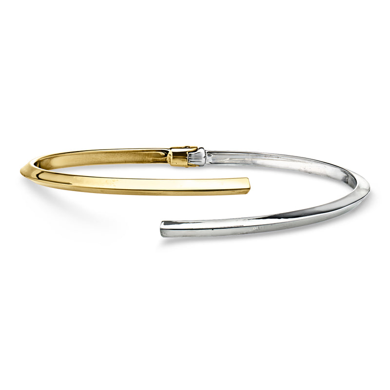 Two-tone 14kt gold bypass cuff bracelet with baguette-cut stone detail, rectangular clasp
