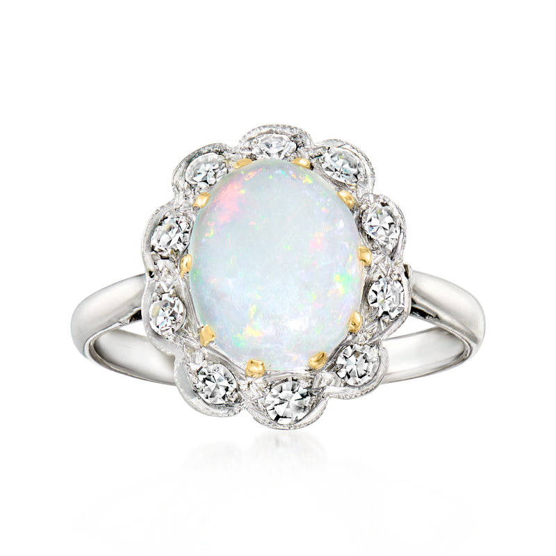 Vintage opal ring with oval opal center, diamond halo, and split white gold band