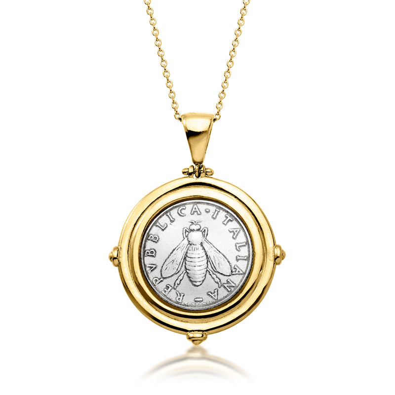 Round gold coin pendant necklace with central coin medallion and bail on chain