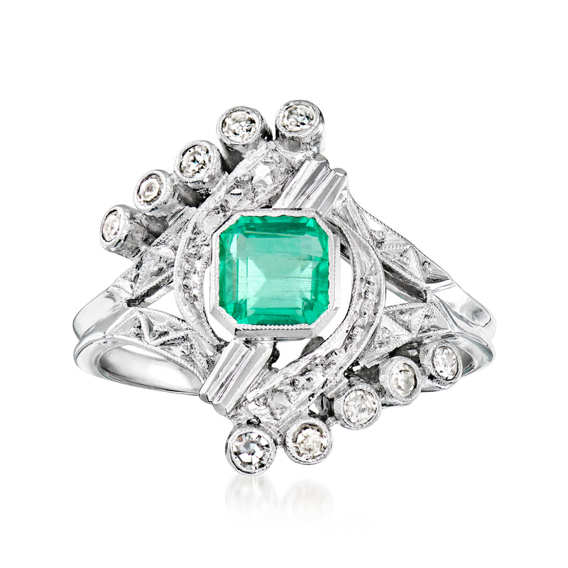 Vintage emerald-cut green gemstone ring in 14kt white gold with round diamond halo