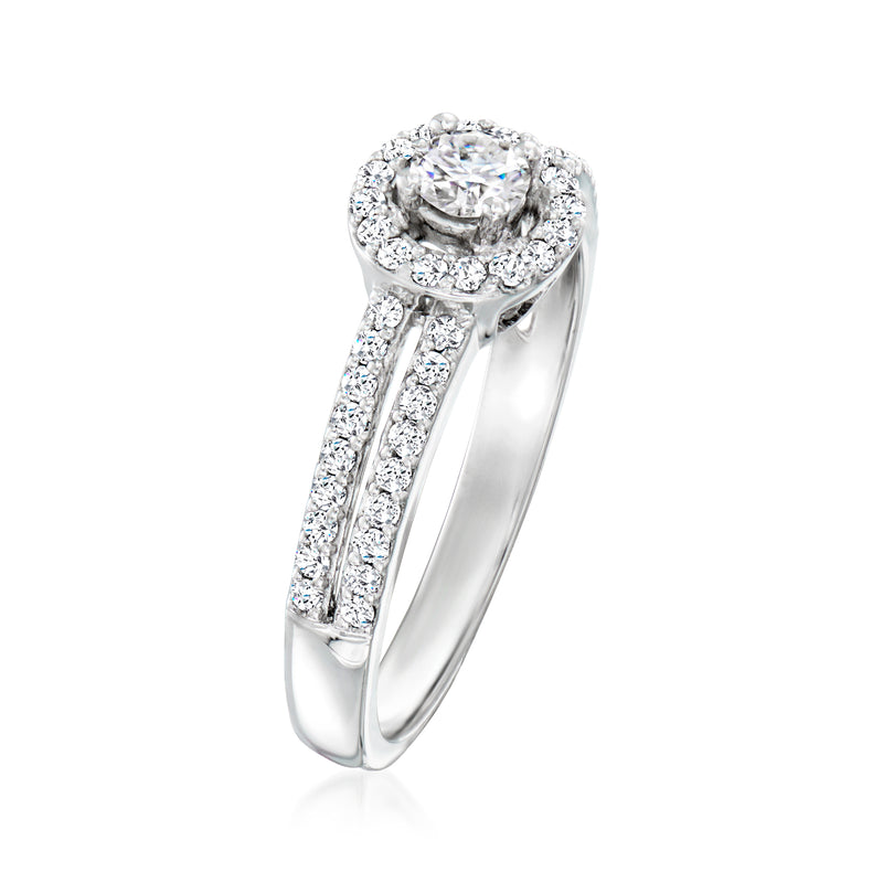Platinum diamond ring with round halo center and prong-set side stones