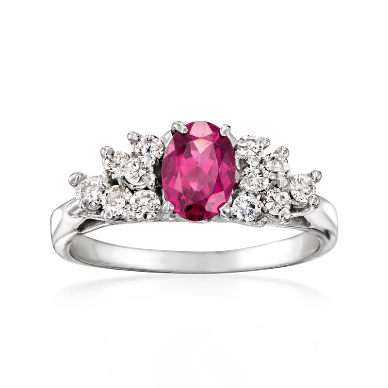 Oval pink gemstone ring in white gold with diamond cluster halo and band