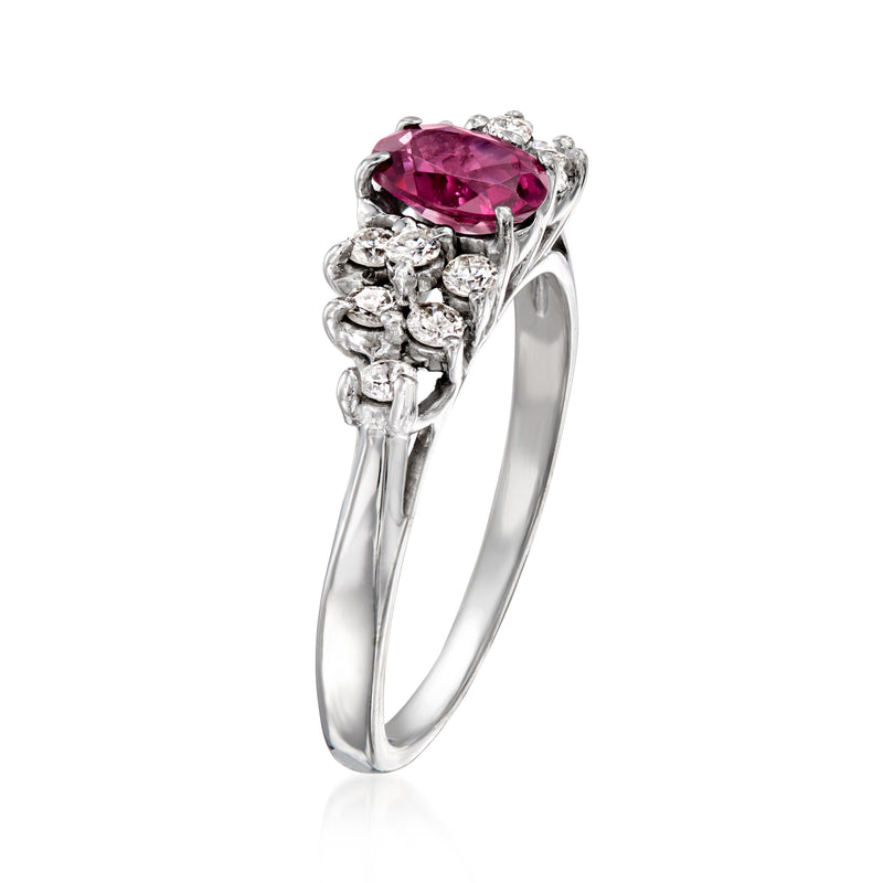 White gold ring with oval pink gemstone and side diamond clusters