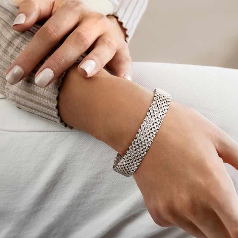 Silver beaded cuff bracelet on wrist, rhodium-plated mesh with end posts