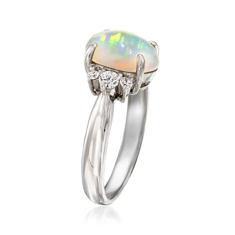 Platinum opal ring with oval opal bezel, round diamonds, and marquise side accents