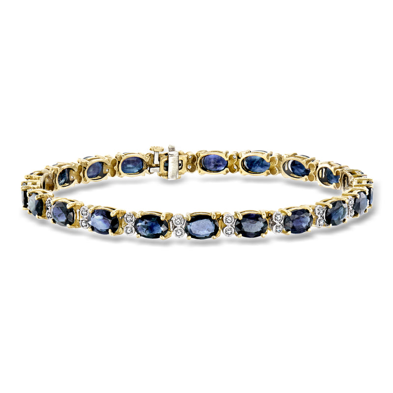 Yellow gold sapphire tennis bracelet with round blue stones and diamond accents