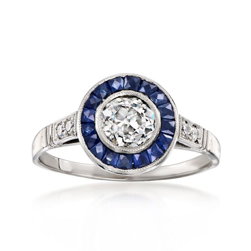 Platinum vintage diamond and sapphire ring with round center stone and blue halo