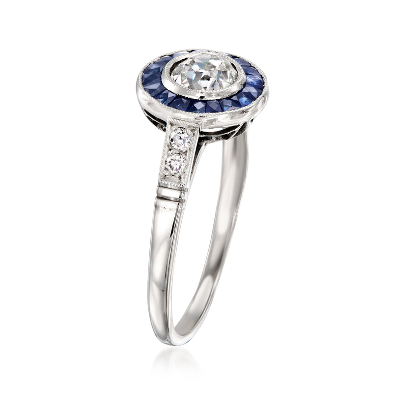 Platinum vintage ring with round diamond center, blue sapphire surround, gem-set shank