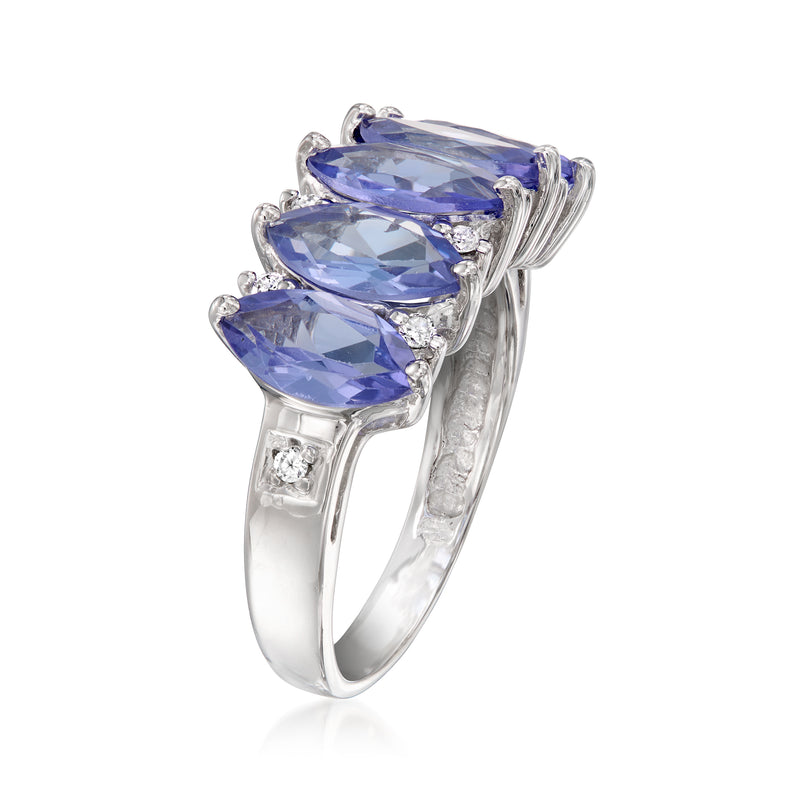 Prong-set blue tanzanite ring with small diamond accents on 14kt white gold band