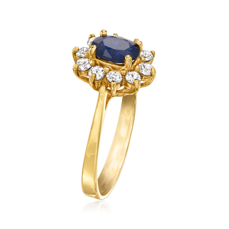 14kt yellow gold ring with oval blue sapphire center and round diamond cluster