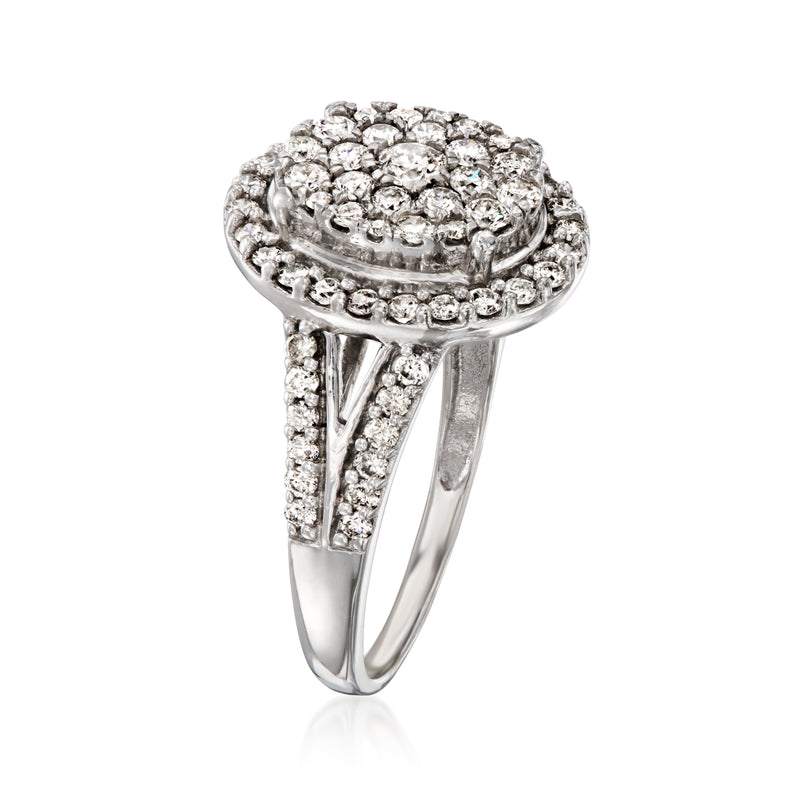 White gold oval diamond halo cluster ring with prong-set center and side stones