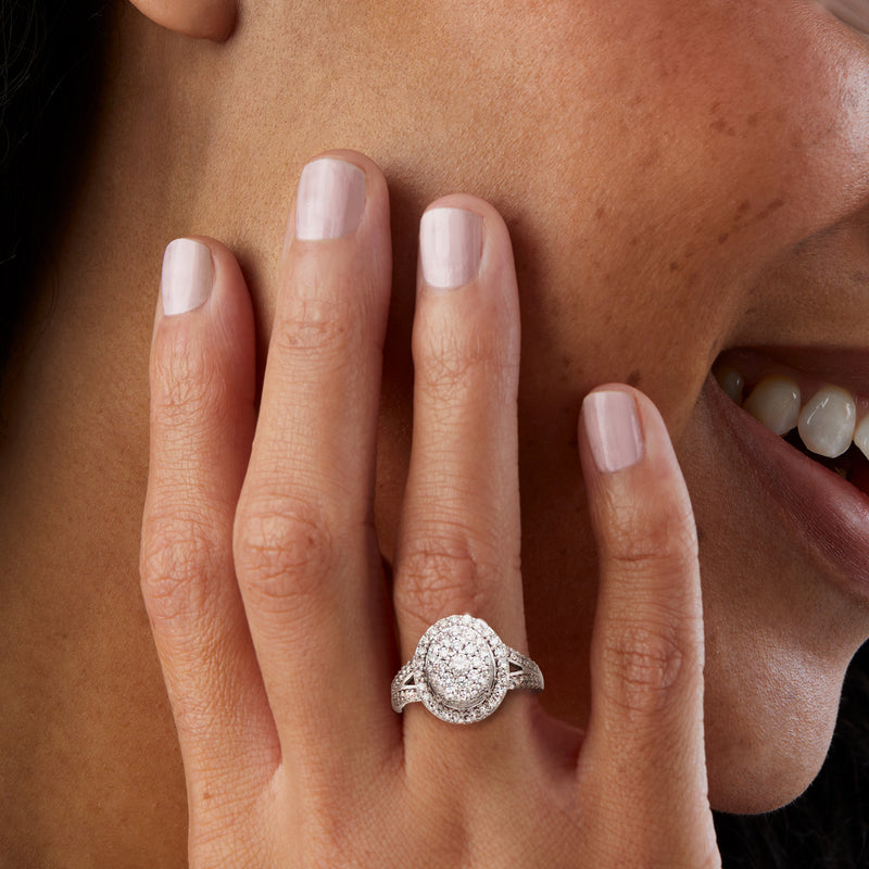 Vintage oval diamond cluster ring in 10kt white gold on a hand